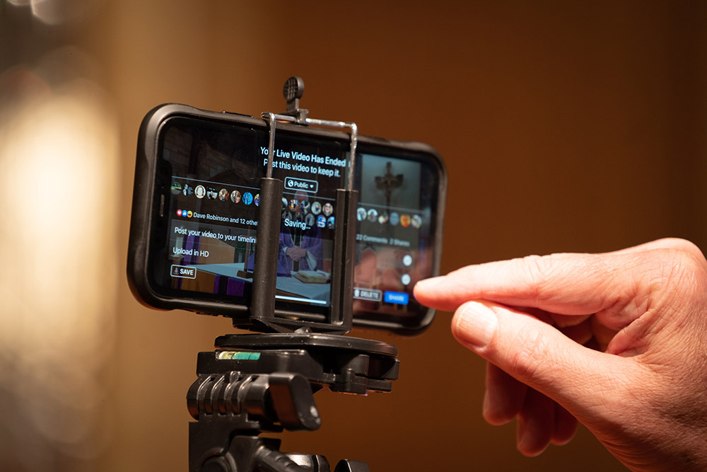 Fr. Tom Kovatch ends a livestreamed Mass that he broadcast on Facebook Live from St. Charles Borromeo Catholic Church in Bloomington, Indiana, March 24, 2020, during the coronavirus pandemic. (CNS/Katie Rutter)