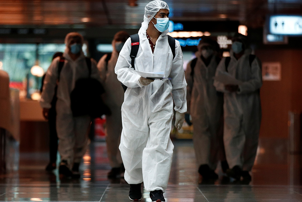 Seafarers who have spent months working onboard vessels during the COVID-19 pandemic arrive June 12, 2020, at Changi Airport in Singapore. (CNS/Edgar Su, Reuters)