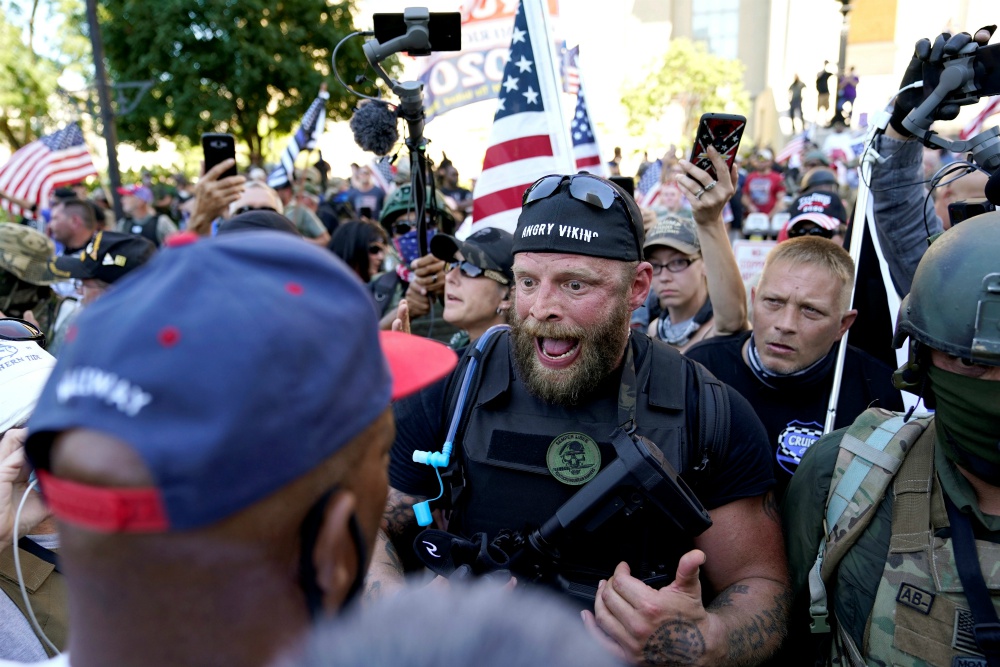 White militia members in Louisville, Kentucky, confront Black Lives Matter activists Sept. 5. (CNS/Reuters/Bryan Woolston)