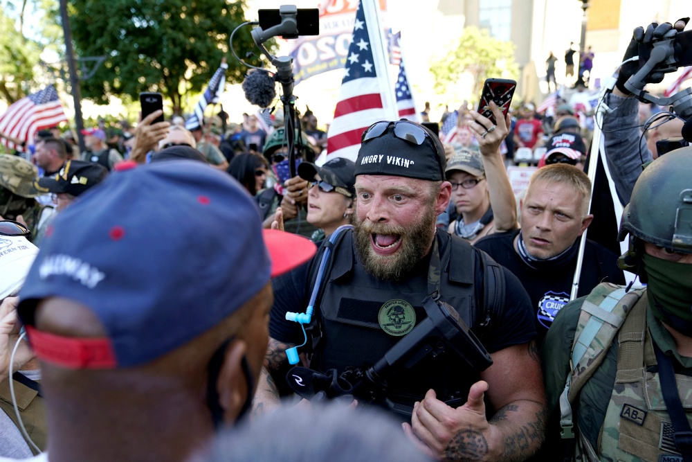 White militia members in Louisville, Kentucky, confront Black Lives Matter activists Sept. 5. (CNS/Reuters/Bryan Woolston) White militia members in Louisville, Kentucky, confront Black Lives Matter activists Sept. 5. (CNS/Reuters/Bryan Woolston)