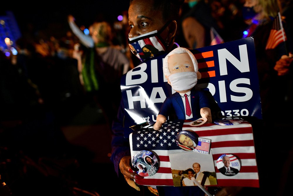 A supporter holds a Biden figurine during President-elect Joe Biden's victory speech Nov. 7 in Wilmington, Delaware. (CNS/Mark Makela, Reuters)