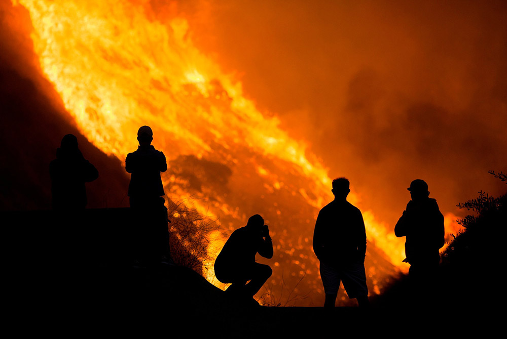 People in Yorba Linda, California, are seen near the Blue Ridge Fire Oct. 26. (CNS/Ringo Chiu, Reuters)