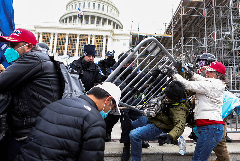 Law enforcement officers push back against supporters of President Donald Trump attempting to enter the U.S. Capitol in Washington Jan. 6, 2020, during a protest against the certification of the 2020 presidential election. (CNS/Jim Urquhart, Reuters)