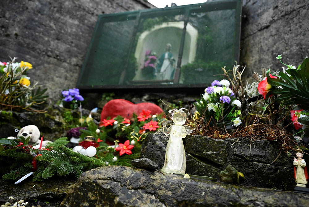 An angel and statue of Mary are pictured at a cemetery in Tuam, Ireland, where the bodies of nearly 800 infants were uncovered at the site of a former Catholic home for unmarried mothers and their children. The photo was taken Jan. 12, the day a commissio An angel and statue of Mary are pictured at a cemetery in Tuam, Ireland, where the bodies of nearly 800 infants were uncovered at the site of a former Catholic home for unmarried mothers and their children. The photo was taken Jan. 12, the day a commissio
