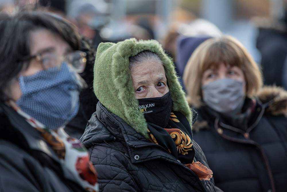 People wearing protective masks wait in line Jan. 26 to receive the Chinese Sinopharm COVID-19 vaccine in Belgrade, Serbia. (CNS/Reuters/Marko Djurica)