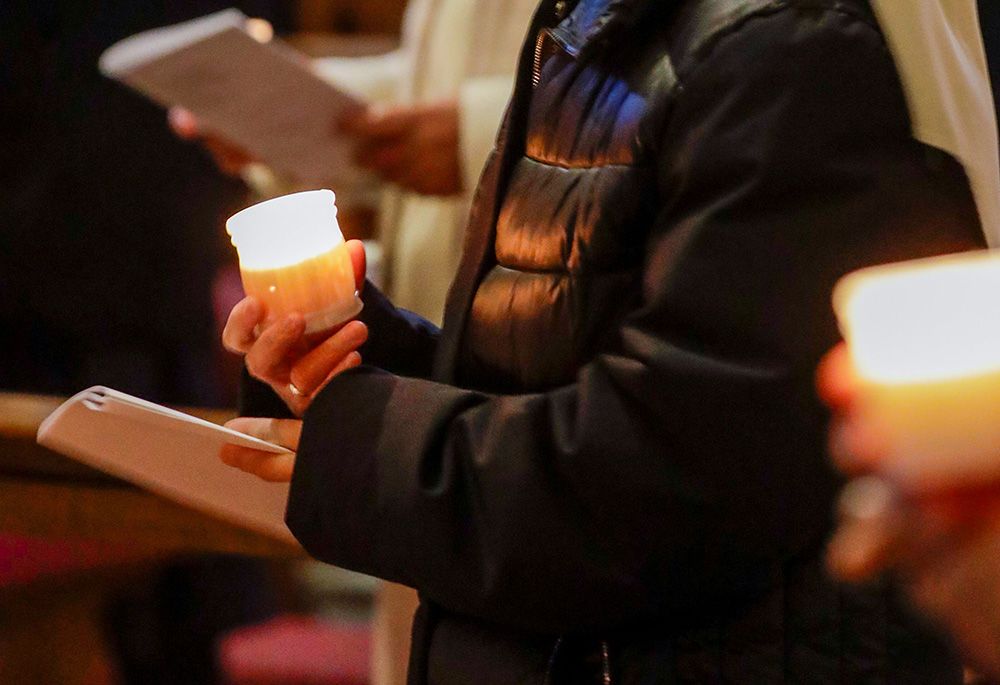 Nuns hold candles as Pope Francis celebrates Mass marking Candlemas and the World Day for Consecrated Life in St. Peter's Basilica Feb. 2, 2021, at the Vatican. (CNS/Andrew Medichini, Reuters pool)