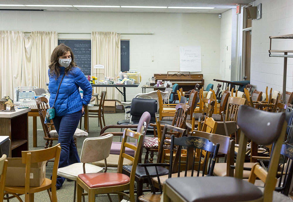 A woman in Farmington Hills, Michigan, browses items March 19 at the estate sale held by the Sisters of Mercy as they clean out their former convent. (CNS/Jim West)