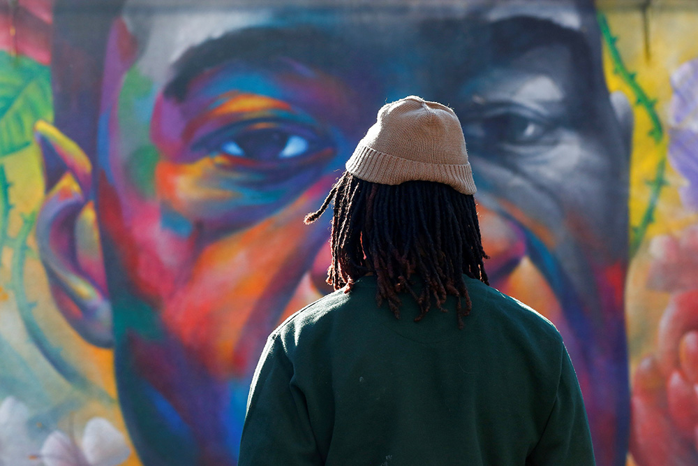 A person in Denver is seen at a George Floyd mural April 20 after jurors issued their verdict convicting former Minneapolis police officer Derek Chauvin of second-degree unintentional murder, third-degree murder and second-degree manslaughter. (CNS)