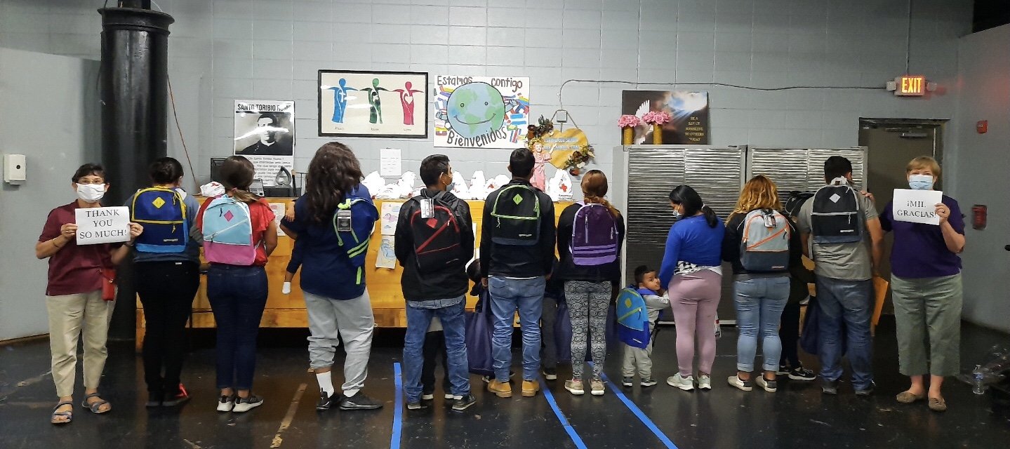 Mercy Sr. Terry Saetta, far left, and Mercy Sr. Patricia Mulderick, far right, pose May 7 at the respite center in McAllen, Texas, where they volunteered to help migrants. (CNS/Courtesy of the Sisters of Mercy)