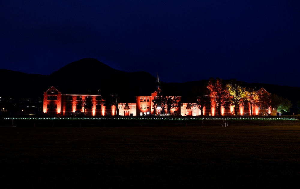 Lights illuminate shoes and stuffed toys outside of the former Kamloops Indian Residential School on June 6. The remains of 215 children, some as young as 3 years old, were found at the site in May in Kamloops, British Columbia. Pope Francis expressed his