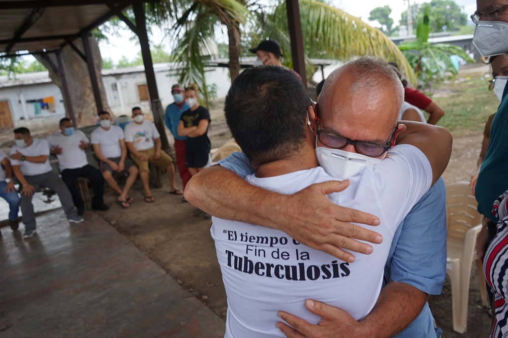 José Artiga, executive director of SHARE, with glasses, embraces one of the detained environmental activists in early July at "Guapinol 8," where the activists have been detained for two and a half years for protesting against a mine polluting the Guapino