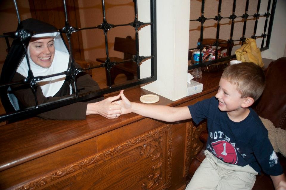 Mother Mary Paschal of the Lamb of God thumb-wrestles with her nephew, James Donahue, in 2011.