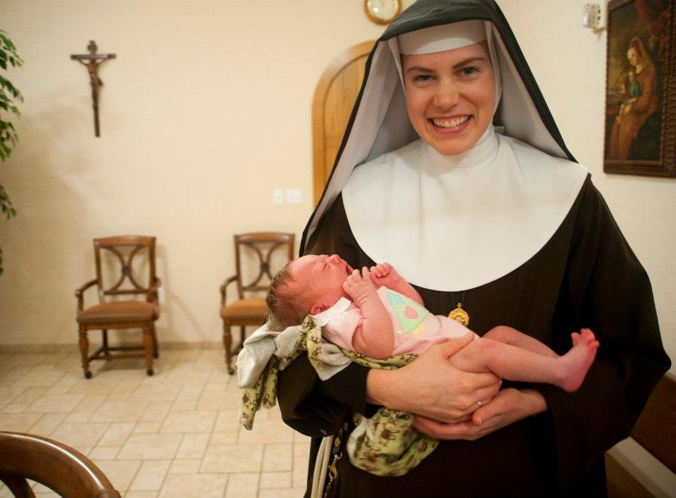 Mother Mary Paschal of the Lamb of God holds her infant niece, Cecelia Potee, in 2011.