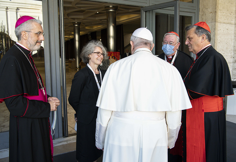 Pope Francis talks with officials of the Synod of Bishops during a meeting with representatives of bishops' conferences from around the world Oct. 9, 2021, at the Vatican.  (CNS/Paul Haring)