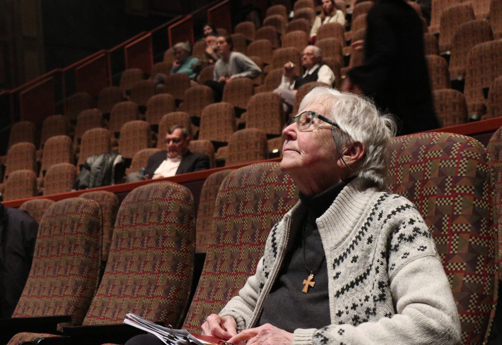 Sister Megan Rice, a member of the Society of the Holy Child Jesus, looks up at the movie screen in the DeBartolo Performing Arts Center April 8, 2018, at the University of Notre Dame in South Bend, Ind., awaiting the screening of a documentary about her 