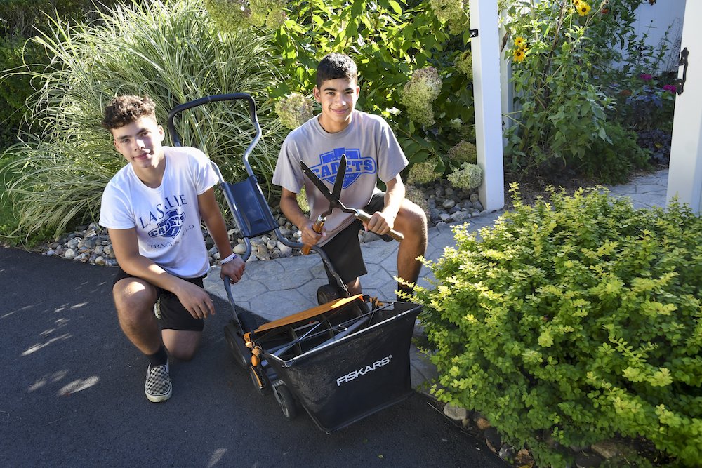 Business partners and twin brothers Brendan, left, and Patrick McNaughton, 16, started an environmentally friendly lawn care business in Albany, New York, called Zero Carbon Lawn Care. (CNS photo/Cindy Schultz, The Evangelist)