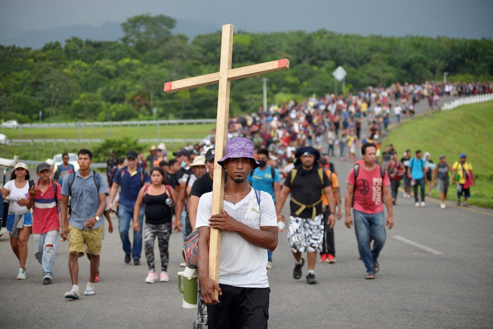 Migrants from Central America and Haiti walk in a caravan Oct. 25 near Huehuetan, Mexico. People were headed to Mexico City where they planned to apply for asylum and refugee status. (CNS/Reuters/Jacob Garcia)