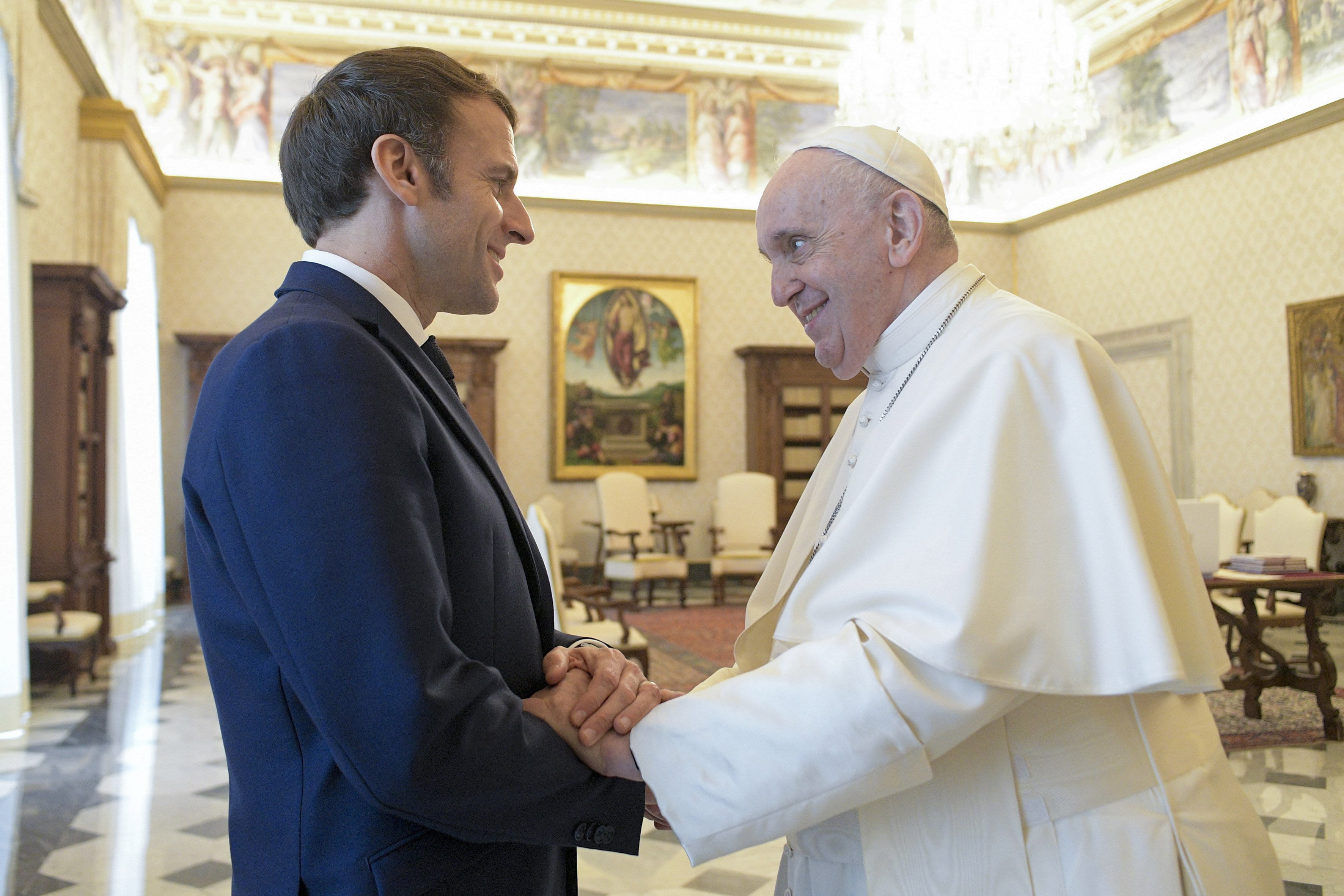 Pope Francis shakes hands with French President Emmanuel Macron during an audience at the Vatican Nov. 26, 2021. (CNS photo/Vatican Media)