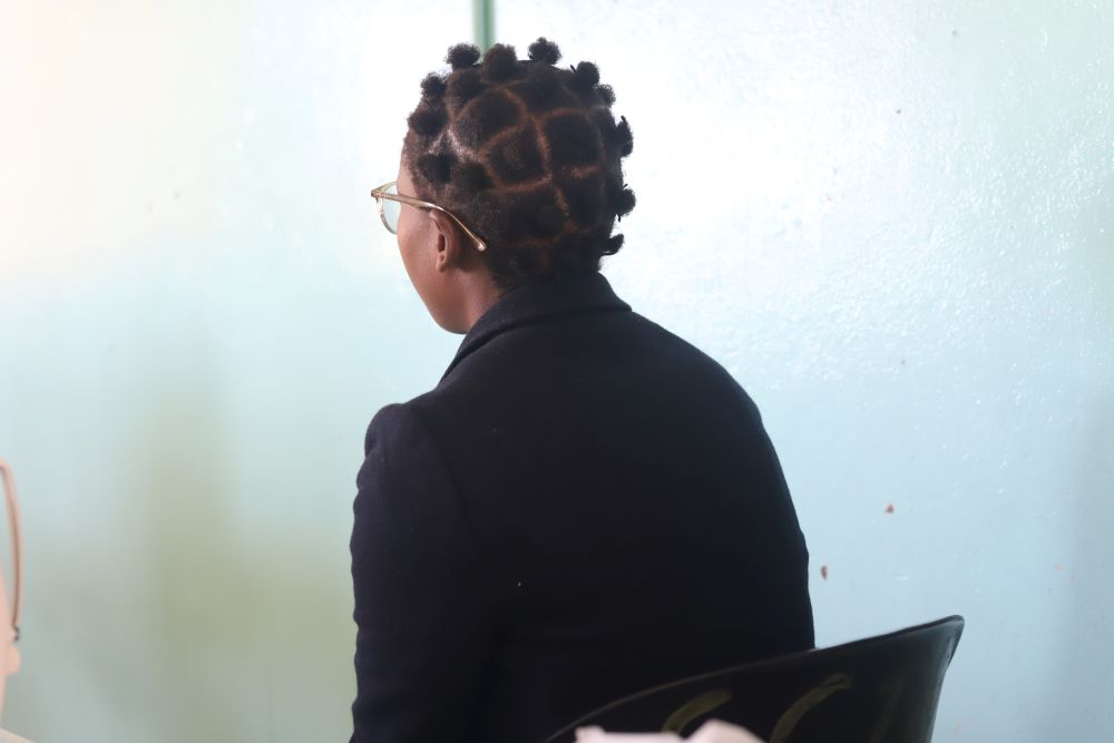 young woman, back to camera, talking 