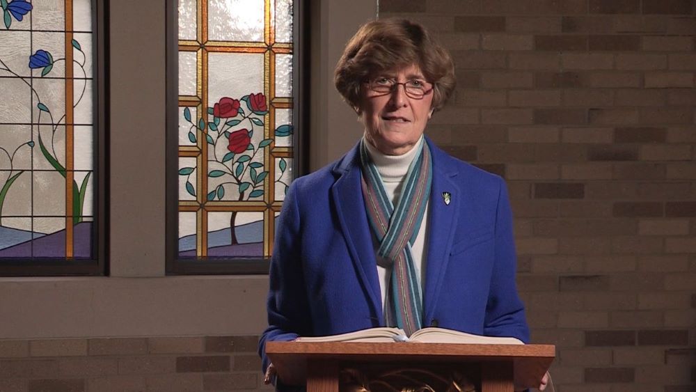 Woman standing at lectern