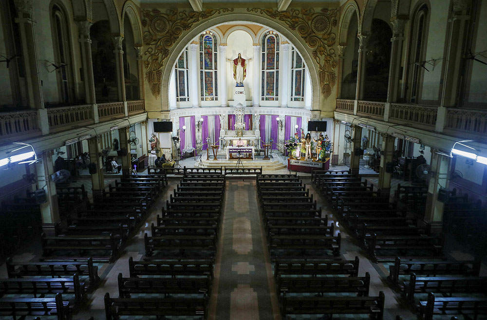 A priest celebrates Mass for a live telecast in an empty church during the coronavirus pandemic in Mumbai, India, March 21, 2020. (CNS/Reuters/Francis Mascarenhas)