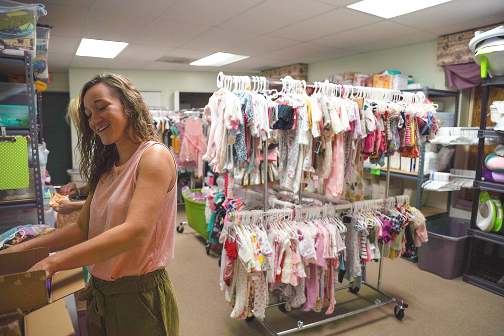 Emily Fitzgerald helps out in the clothing closet at the Lennon Pregnancy Center in Dearborn Heights, Michigan, on July 21. (CNS/Detroit Catholic/Valaurian Waller)