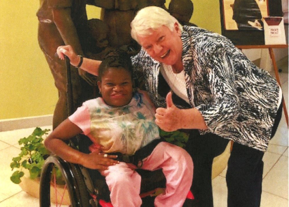 Sr. of Charity Nuala Patricia Kenny poses with a patient. 