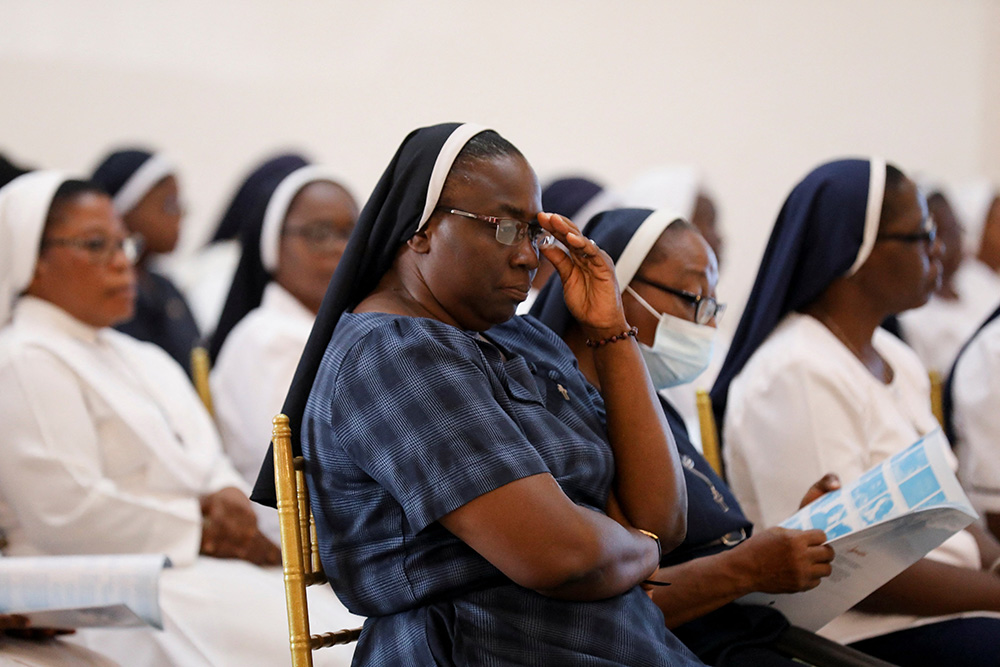 Nuns attend a mass funeral service in the parish hall of St. Francis Xavier Church in Owo, Nigeria, June 17, 2022. The service was for at least 50 victims killed in a June 5 attack by gunmen during Mass at the church. (CNS/Reuters/Temilade Adelaja)