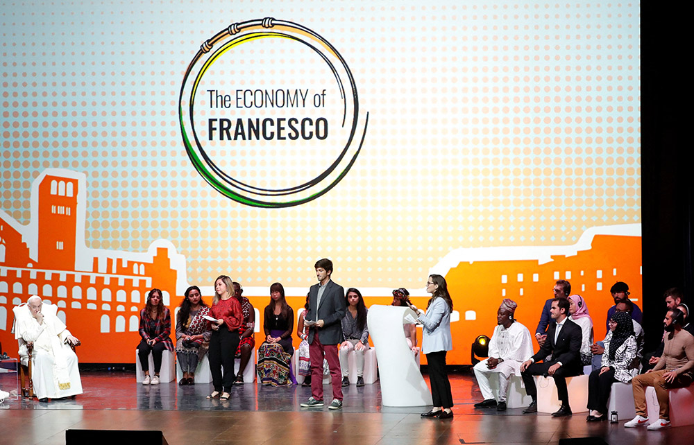 Pope Francis is welcomed to Assisi, Italy, Sept. 24 by young economists, entrepreneurs, financial advisers, scholars and scientists who have been working for two years on the Economy of Francesco project. (CNS/Reuters/Remo Casilli)