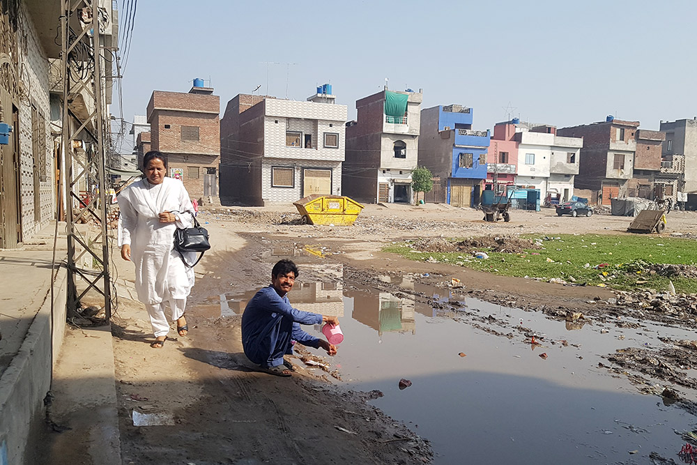 St. Joseph of Chambery Sr. Shakila Bhatti walks in China Scheme, a neighborhood of Lahore, Pakistan. (GSR photo/Kamran Chaudhry)