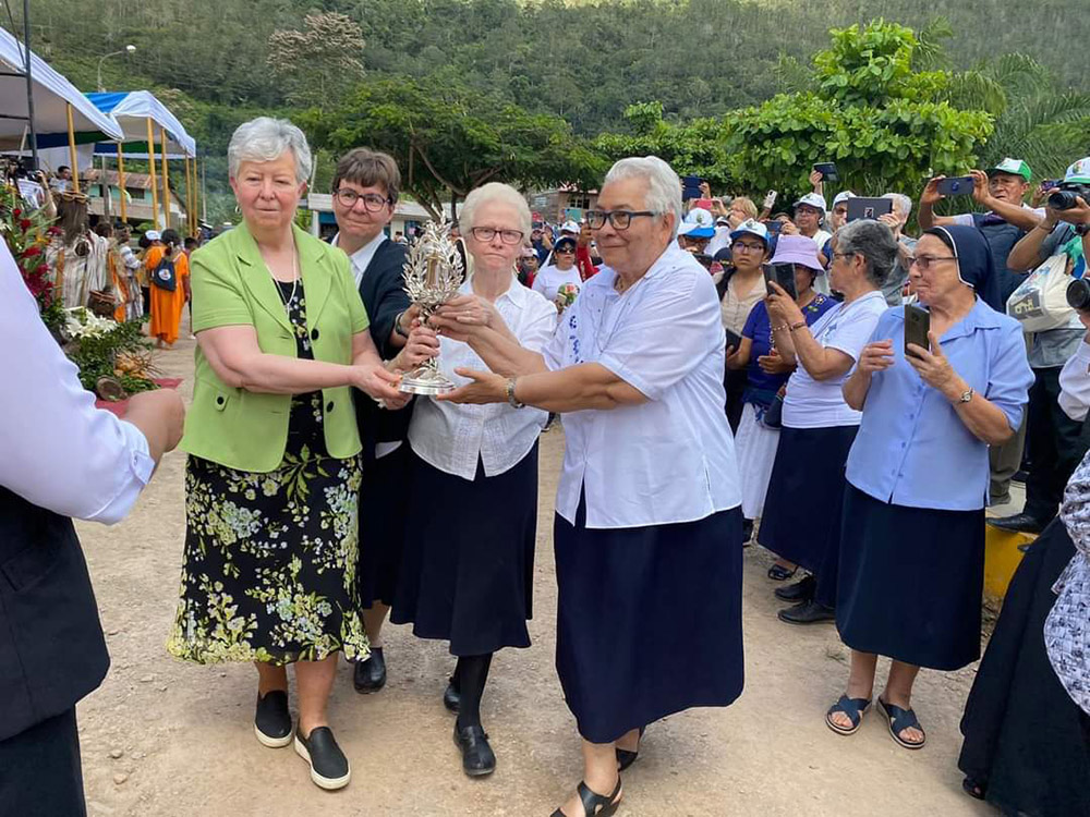 During the beatification ceremony for Sr. María Agustina Rivas López — affectionately known as Aguchita — on May 7 in La Florida, Peru, members of the Congregation of Our Lady of Charity of the Good Shepherd carry a reliquary containing bones of Aguchita. From left are Srs. Ellen Kelly, outgoing congregational leader; Mirjam Beike, new councilor; Yvette Arnold, procurator general; and Maria Susana Franco, outgoing vicar general. (Courtesy of Yvette Arnold)