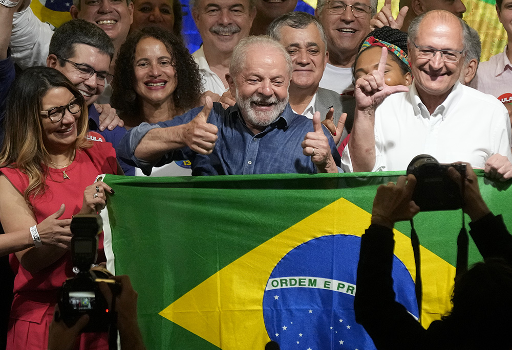 Former Brazilian President Luiz Inácio Lula da Silva celebrates with his wife Rosangela Silva, left, and running mate Geraldo Alckmin, right, after defeating incumbent Jair Bolsonaro in a presidential run-off to become the country's next president, Oct. 30 in São Paulo, Brazil. (AP photo/Andre Penner)