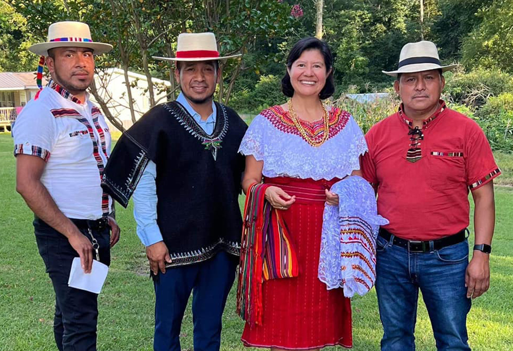 Sr. Gabriela Ramírez of the Guadalupan Missionaries of the Holy Spirit poses for a photo with men of the Mayan community in Birmingham, Alabama. (Courtesy of Gabriela Ramírez)