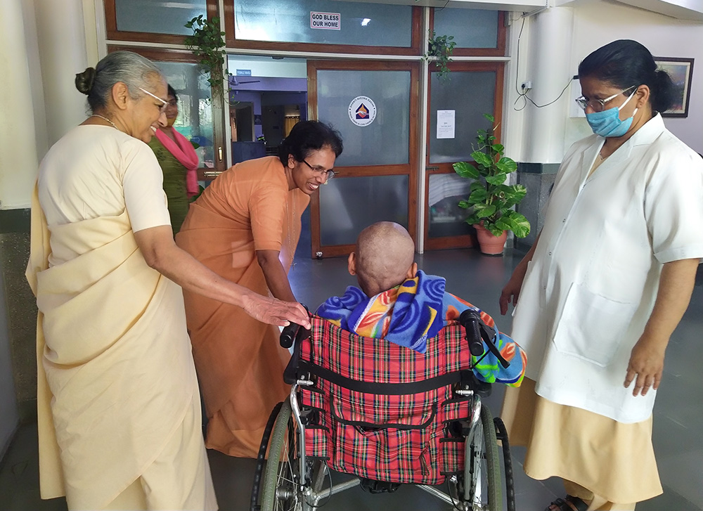 Holy Cross sisters welcome a new patient to Shanti Avedna Sadan in New Delhi. Standing from left: Holy Cross Srs. Alexia Pullooruthukkariyil, Tabitha Joseph and Felcy Mullor (Jessy Joseph)