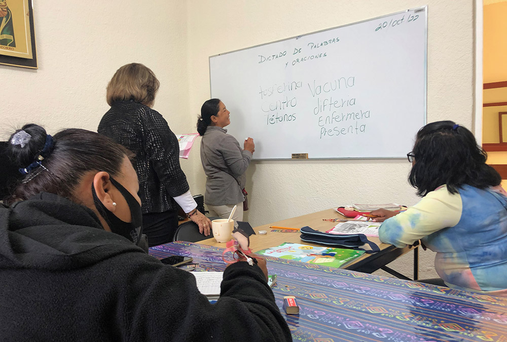 Josefina, who is studying to get her middle school certification, practices her vocabulary as Sr. Rosa Aguayo, behind her, and fellow students look on. (GSR photo/Tracy Barnett)