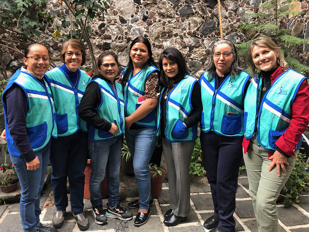 The sisters and their helpers pose in the patio of La Palmita for a photo after a recent abordaje, or outreach session in the streets of La Merced. From left are Novice Sister Isaura, Sr. Manuela Rodríguez, Mariana Gutierrez, Cecilia Martínez, Sr. María Rosas, Sr. Carmen Paz and journalist Tracy Barnett. (Courtesy of Tracy Barnett)