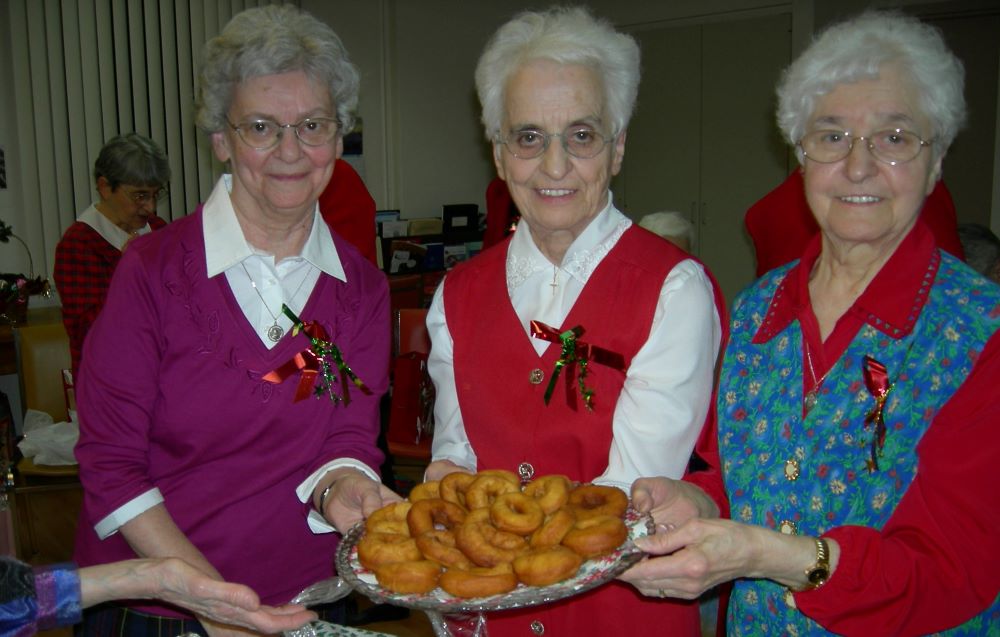 sisters with a plate of doughnuts