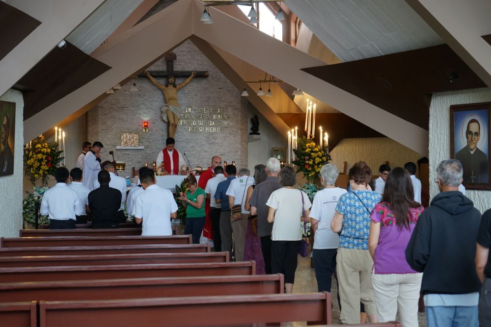 Delegates on the 2022 Roses in December trip line up for Communion on Nov. 30 at the Hospital Divina Providencia chapel in San Salvador, El Salvador, the hospital chapel where St. Óscar Romero was assassinated in 1980. (Courtesy of the SHARE Foundation)