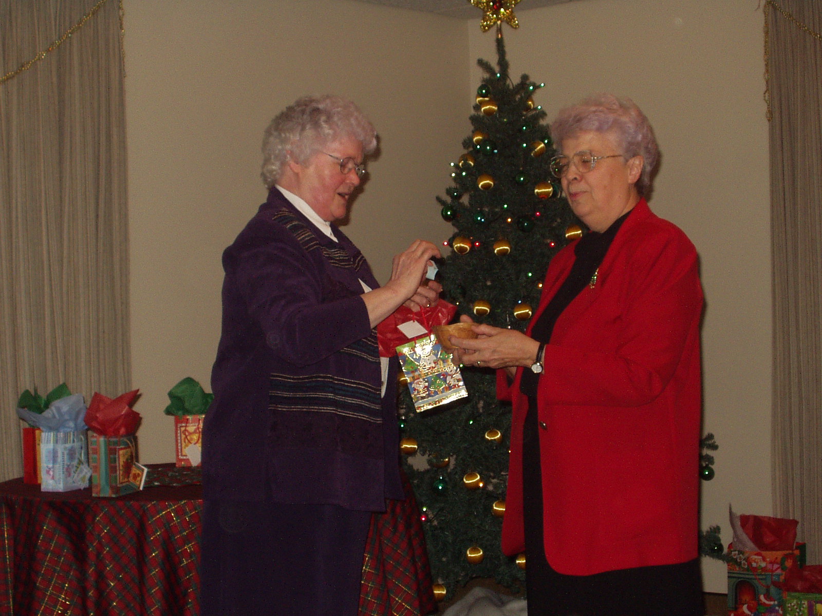 Srs. Irène Bonenfant (left) and Florence Vinet draw names for their community's Kris Kringle Christmas gift exchange in December 2005. (Courtesy of Sisters of the Holy Names of Jesus and Mary Archives, Longueuil, Quebec)