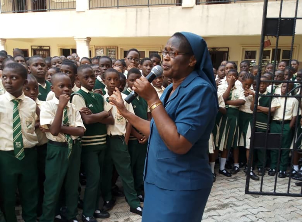 Sr. Bibiana Emenaha of the Daughters of Charity of St. Vincent de Paul speaks to students in February 2019 at a rural school in Edo, Nigeria, on the dangers of trafficking. (CNS/Courtesy of the Committee for the Support of Dignity of Women)