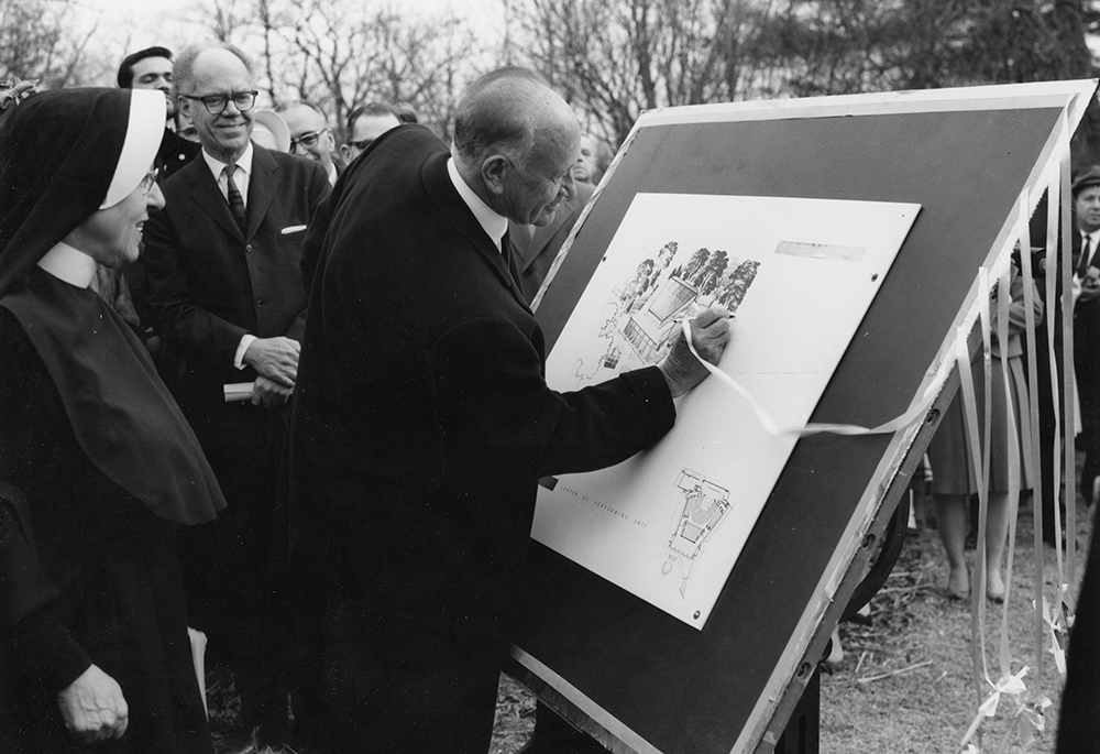 Loretto Sr. Francetta Barberis watches Conrad N. Hilton sign the architect's rendering of the Loretto-Hilton Center for the Performing Arts at the center's 1966 groundbreaking. (Courtesy of Webster University)