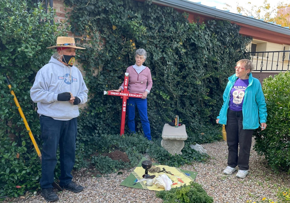 Deacon Gabriel Saspe of Douglas, Arizona, left, invites participants — including Sr. Anita Fearday, center, of the Adorers of the Blood of Christ and Sr. Lucy Nigh of the School Sisters of Notre Dame — to pray at the planting of a memorial cross for Ireny Perez Escalante in the columbaria of St. Andrew the Apostle Catholic Church in Sierra Vista, Arizona. (Peter Tran)