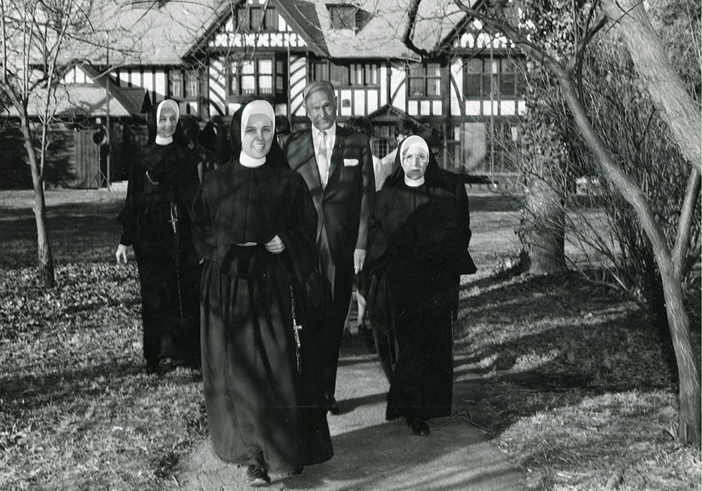 Loretto Sr. Jacqueline Grennan, foreground, and Loretto Sr. Francetta Barberis, far right, walk with Conrad N. Hilton to the groundbreaking for the new theater on the campus of Webster University, then Webster College, in 1966. (Courtesy of Webster University)