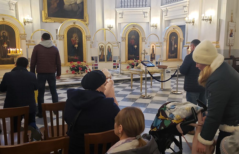 Ukrainian congregants gather for recent Sunday afternoon services at Dormishin Mother of God, a Ukrainian Catholic parish near Warsaw's Old Town. The church has become a center of gathering for Ukrainian refugees now living in Warsaw, Poland. "They look to God for help," said Basilian Fr. Peter Kushka, a priest at the church. "They are afraid." (GSR photo/Chris Herlinger)