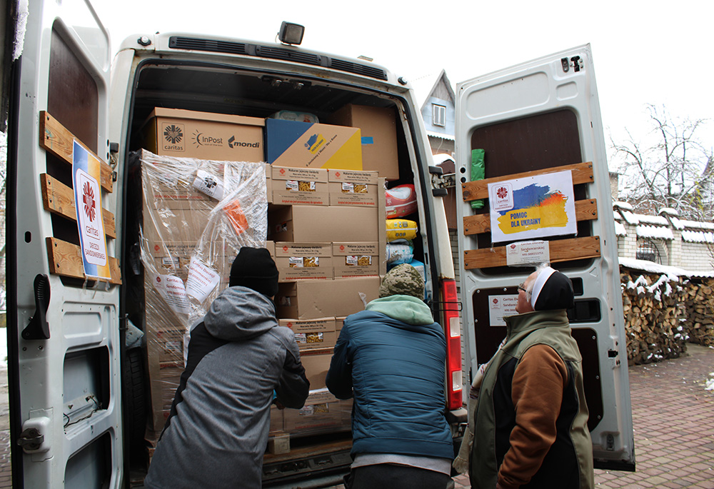 Volunteers help unload a delivery of humanitarian items to a Dominican convent in Zhovkva, Ukraine, provided by Caritas Poland and delivered by three Polish priests. (GSR photo/Chris Herlinger)