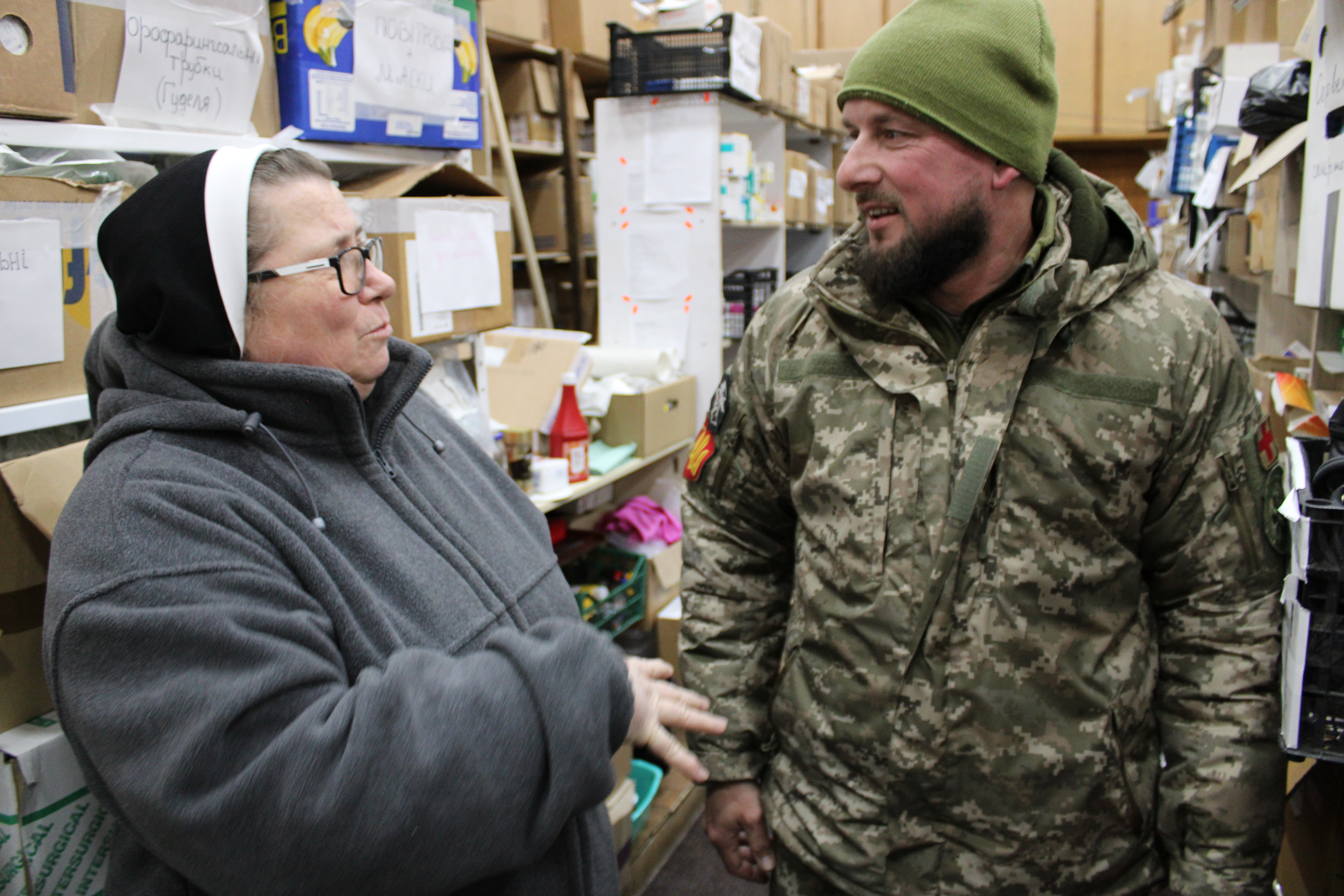 Welder and medical coordinator Vadym Voronin, right, with Dominican Sr. Mateusza Trynda at a humanitarian center in Zhovkva, Ukraine. Voronin, who works at the nearby Yavoriv military base, coordinates the distribution of medical supplies through the volunteer group ICare Ministry but has also worked with the sisters as they provide medical supplies. (GSR photo/Chris Herlinger)