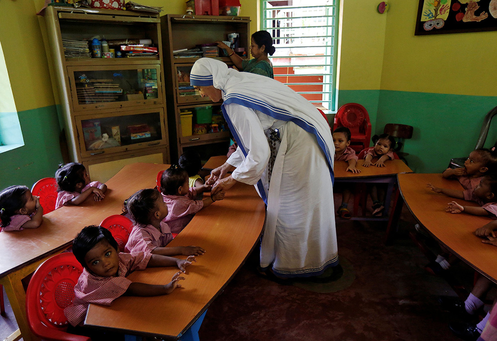 A member of the Missionaries of Charity interacts with the children of a kindergarten Aug. 30, 2016, inside the Nirmala Shishu Bhavan, a home for orphaned, destitute and abandoned children in Kolkata, India. (CNS/Reuters/Rupak De Chowdhuri)