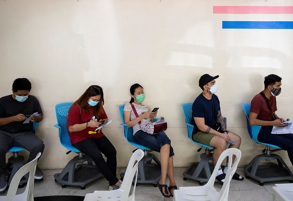 People wait for a booster dose of the COVID-19 vaccine in Manila, Philippines, on Jan. 5. (CNS/Reuters/Eloisa Lopez)