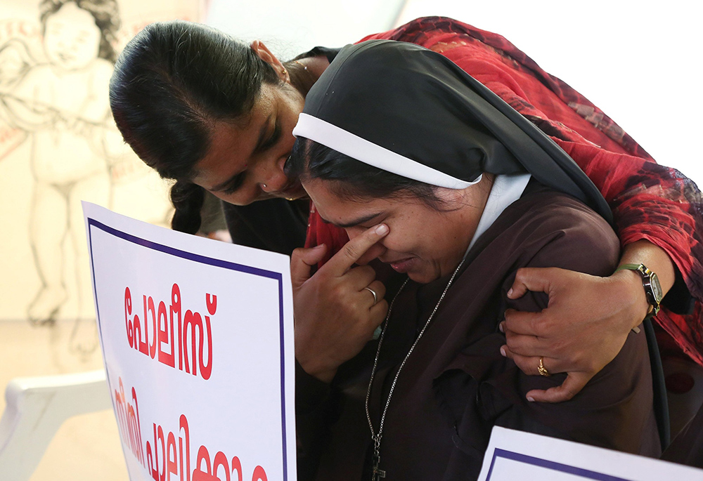 A nun is consoled during a Sept. 13, 2018, protest in Cochin, India. The protest was to demand justice after a former religious superior accused Bishop Franco Mulakkal of Jalandhar of raping her. A court acquitted Mulakkal of all charges Jan. 14. (CNS)