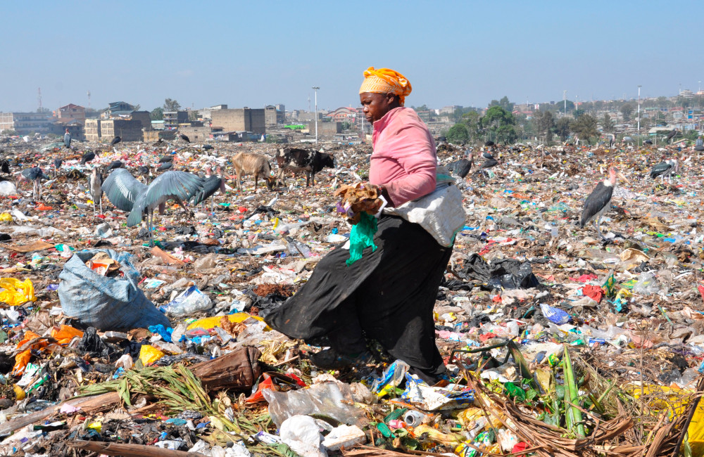 An unidentified woman collects items at the Dandora dumpsite in Nairobi, Kenya, Feb. 26, 2022. The dump attracts poor urban residents who collect recyclable materials for sale. (CNS/Fredrick Nzwili)